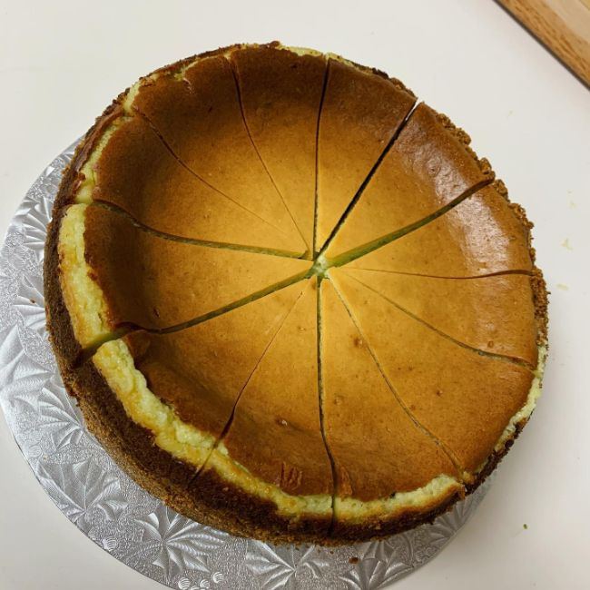 A plain New York style cheesecake, sliced